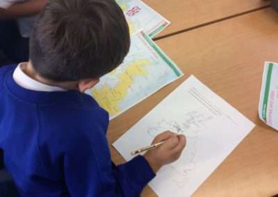 boy writing on map